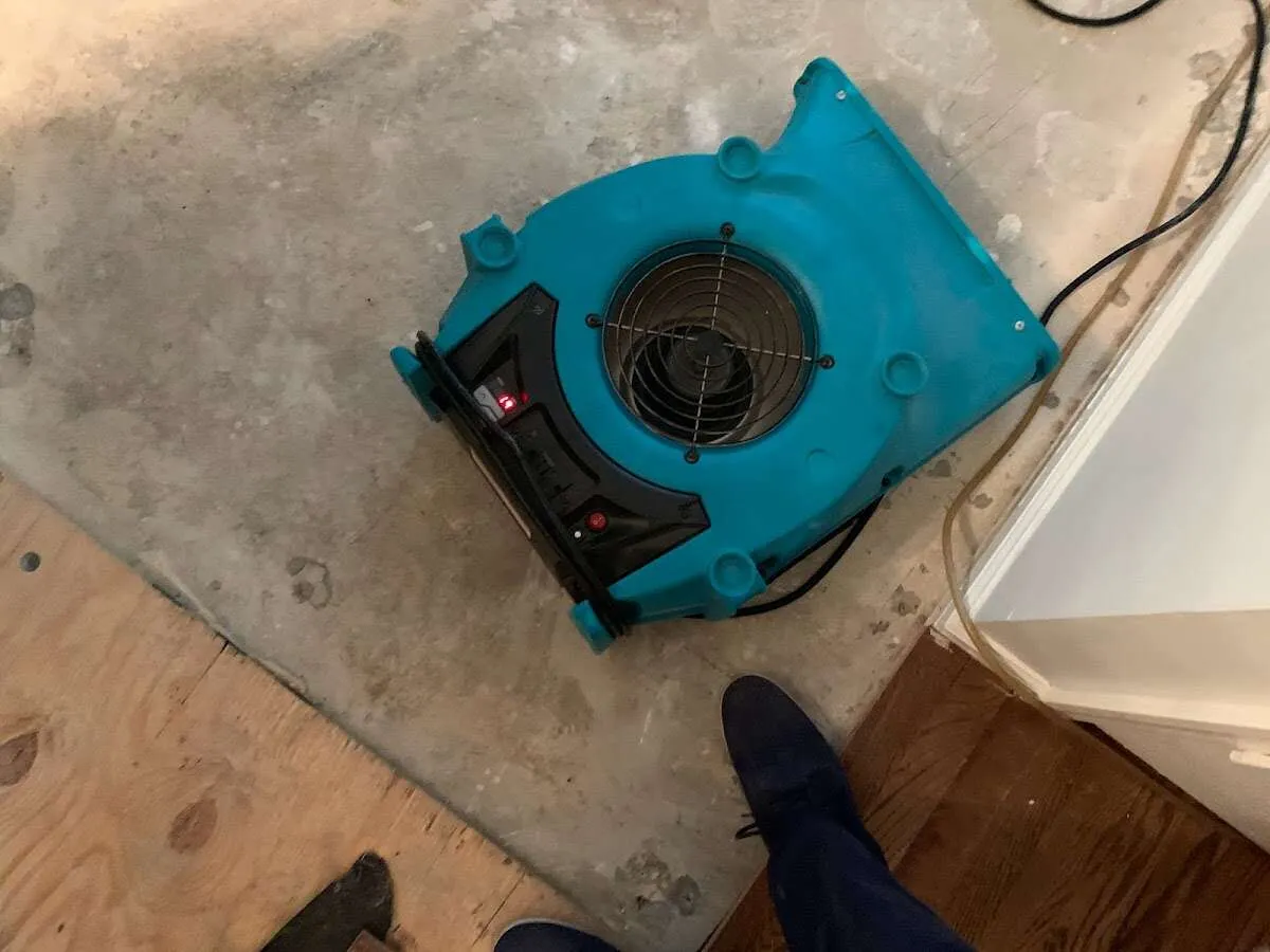 Air mover drying subfloor during Commercial Water Damage Restoration in Huntington Woods